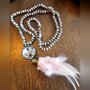 New never worn long beaded necklace with rhinestone and pink feathers